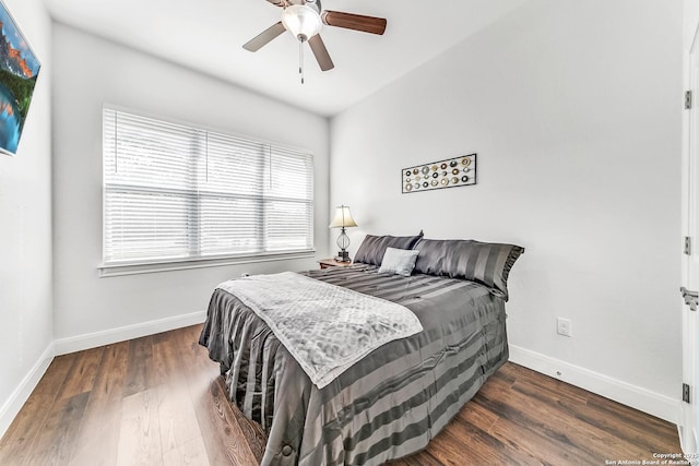 bedroom with dark hardwood / wood-style floors and ceiling fan