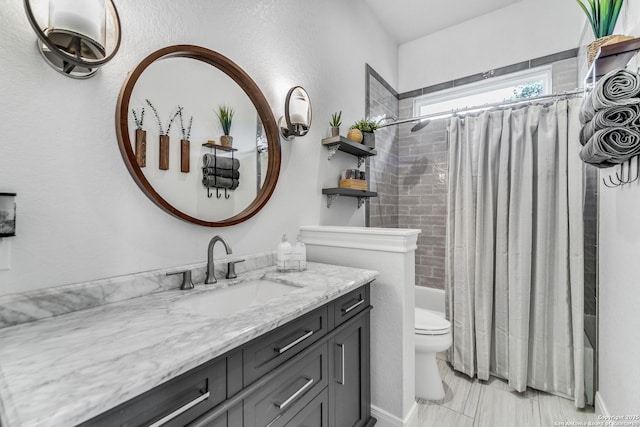 full bathroom with vanity, shower / bath combination with curtain, and toilet