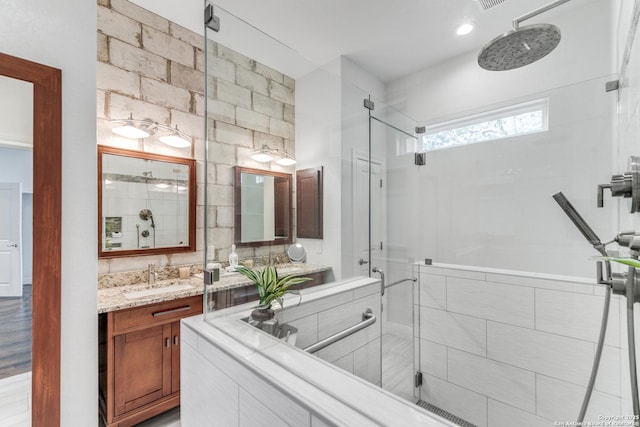 bathroom with vanity and a shower with shower door