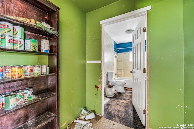 interior space with shower / tub combination and toilet