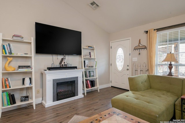 living room with dark wood-type flooring and vaulted ceiling