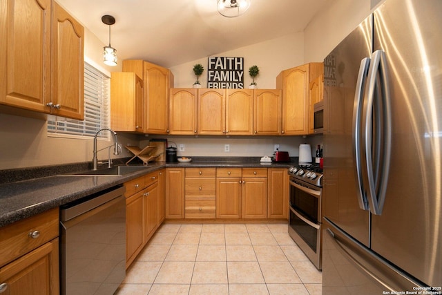 kitchen with pendant lighting, sink, lofted ceiling, appliances with stainless steel finishes, and light tile patterned flooring