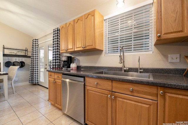 kitchen with sink, vaulted ceiling, dishwasher, and light tile patterned flooring