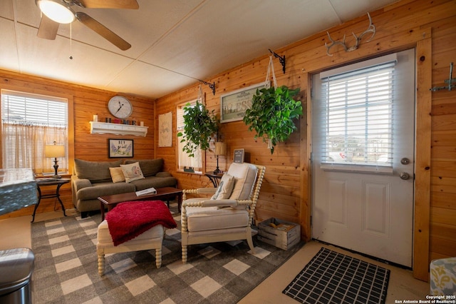 living room with wooden walls and ceiling fan