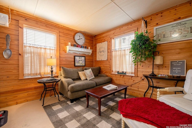 carpeted living room featuring wood walls