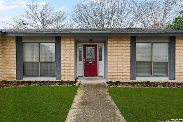 entrance to property with a yard