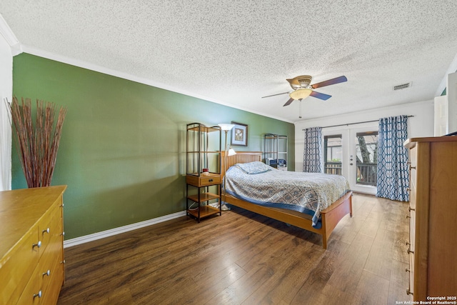 bedroom featuring dark wood-type flooring, french doors, ornamental molding, ceiling fan, and access to exterior