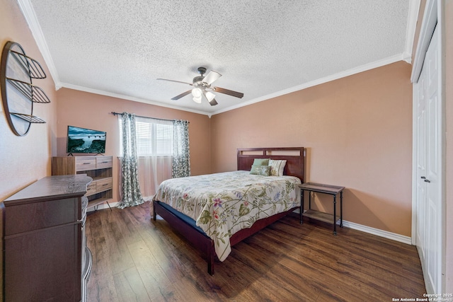 bedroom featuring dark wood-type flooring, crown molding, a closet, and a textured ceiling