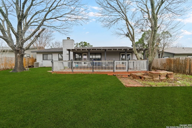 rear view of property featuring a yard, a deck, and central air condition unit