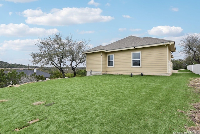 rear view of house with a lawn