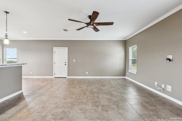 tiled spare room featuring crown molding and ceiling fan