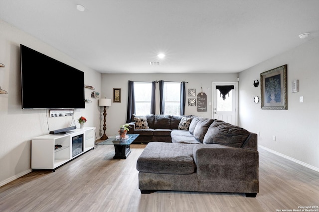 living room with light hardwood / wood-style flooring