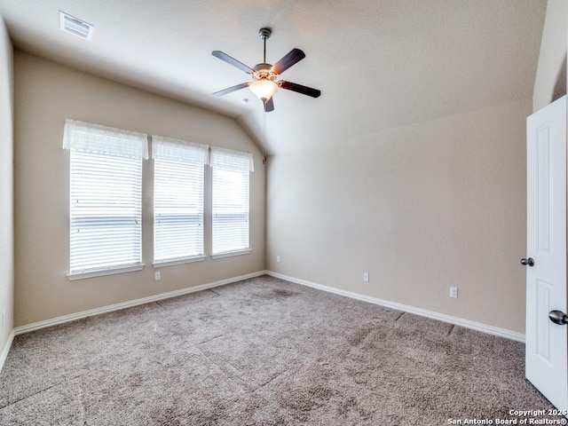 unfurnished room featuring lofted ceiling, carpet floors, and ceiling fan