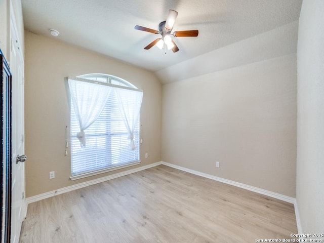 unfurnished room with light hardwood / wood-style flooring, ceiling fan, and vaulted ceiling