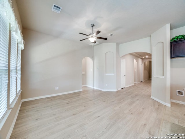 empty room featuring ceiling fan and light hardwood / wood-style flooring