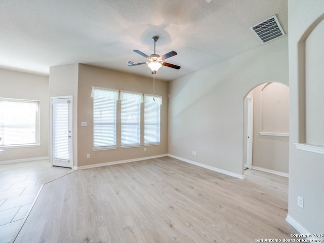 spare room with ceiling fan and light wood-type flooring