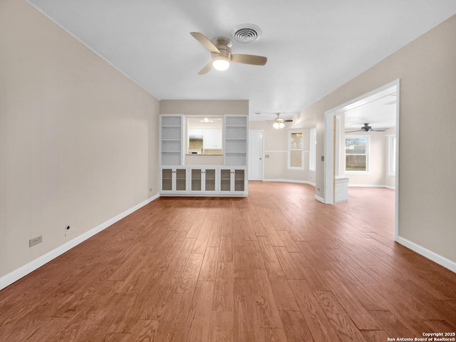 unfurnished living room with hardwood / wood-style flooring and ceiling fan