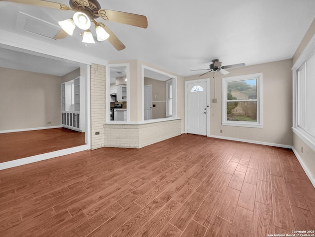 unfurnished living room with hardwood / wood-style floors and ceiling fan