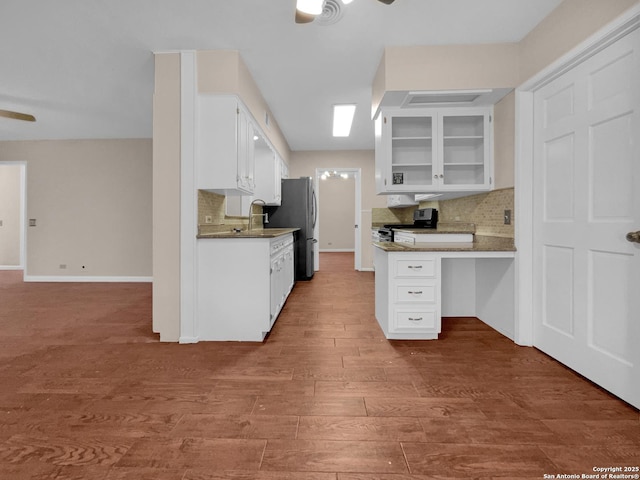 kitchen featuring hardwood / wood-style flooring, appliances with stainless steel finishes, white cabinets, and ceiling fan