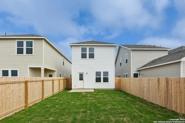 rear view of house with a yard