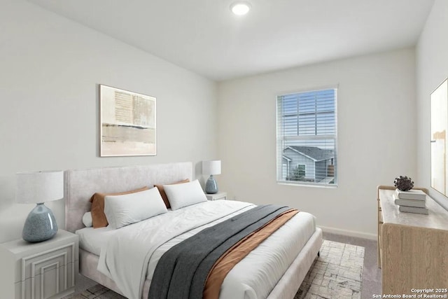 bedroom with multiple windows and light colored carpet