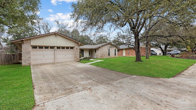 single story home with a garage and a front yard