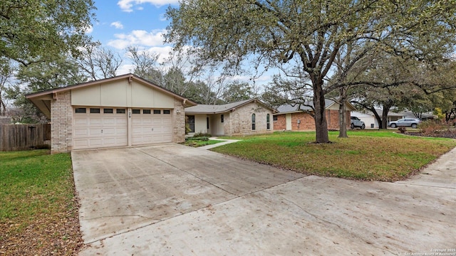 ranch-style house featuring a garage and a front lawn