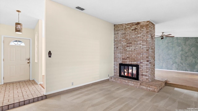 unfurnished living room featuring light colored carpet and a fireplace