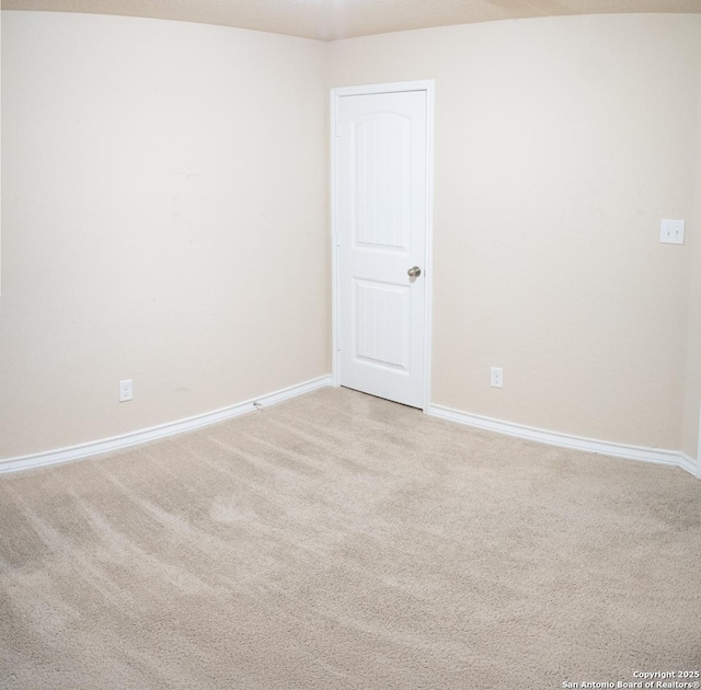 spare room with light carpet