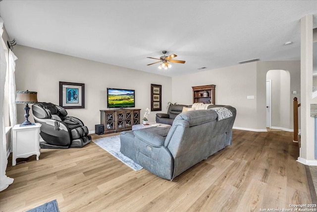 living room with ceiling fan and light hardwood / wood-style flooring