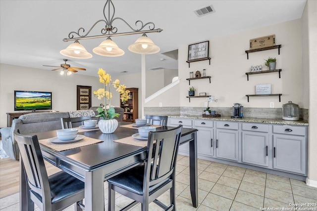 dining area with light tile patterned flooring and ceiling fan