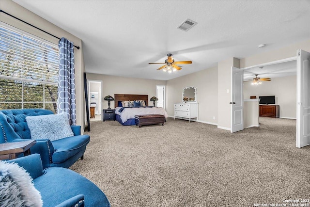 carpeted bedroom with ceiling fan and a textured ceiling