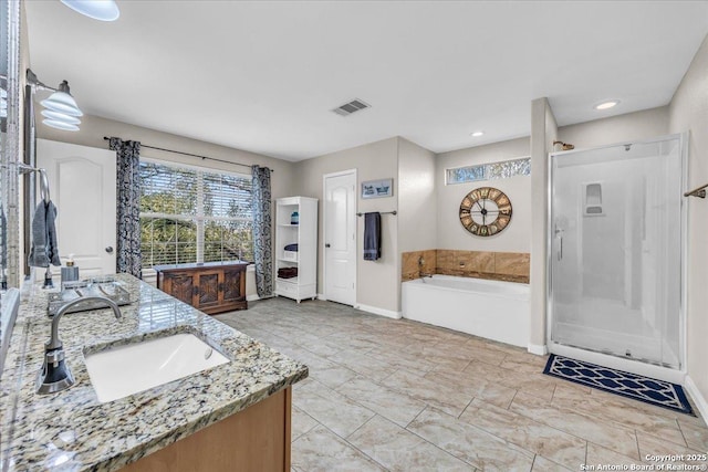 bathroom with vanity and separate shower and tub