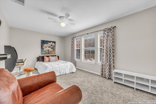 bedroom featuring ceiling fan, carpet floors, and a textured ceiling