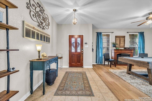 tiled entryway with ceiling fan