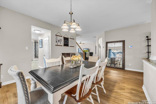 dining space with an inviting chandelier and light hardwood / wood-style floors