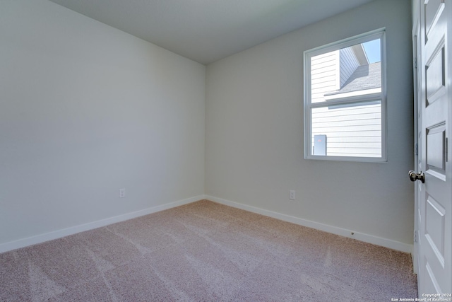 unfurnished room featuring light colored carpet