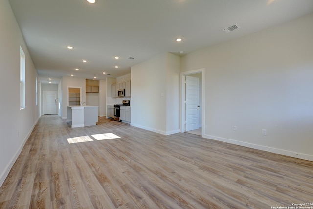 unfurnished living room featuring light hardwood / wood-style flooring