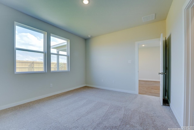 unfurnished room with light carpet