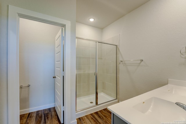 bathroom featuring hardwood / wood-style floors, sink, and walk in shower