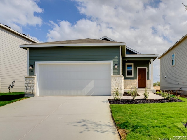 view of front of home with a garage and a front yard