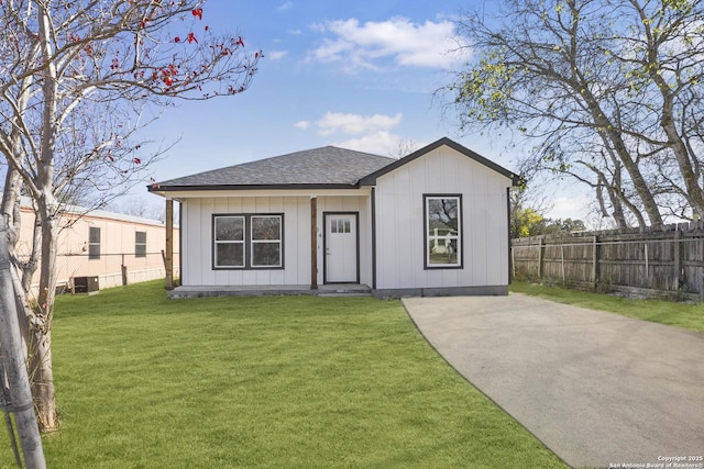 view of front of home with cooling unit and a front yard