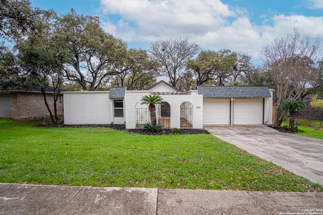 view of front of property with a garage and a front lawn