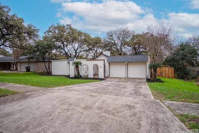 ranch-style home with a garage and a front yard