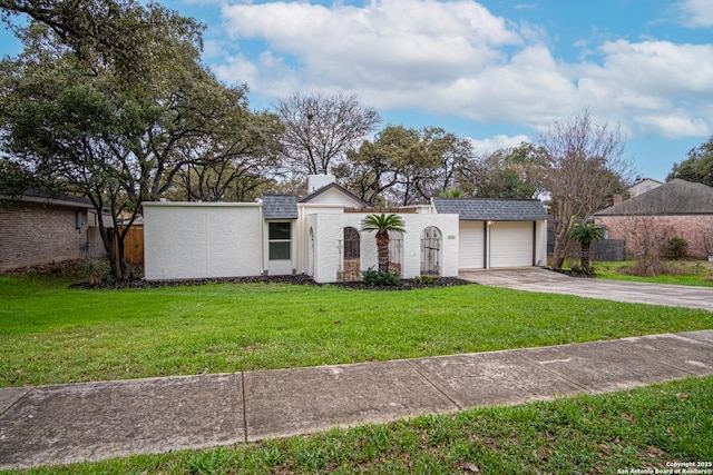 view of front facade with a garage and a front lawn