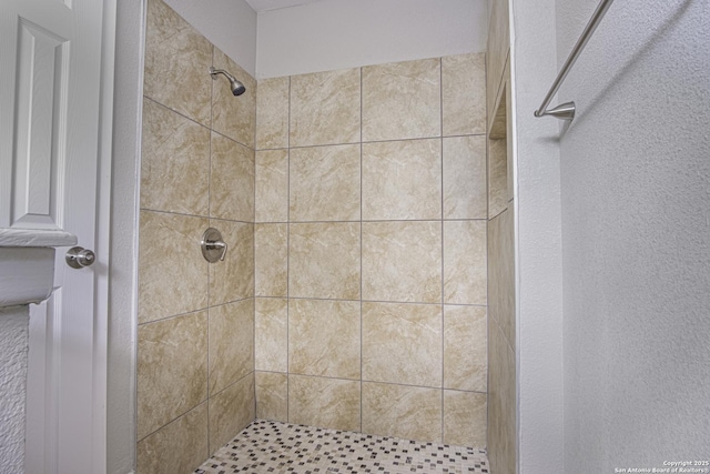 bathroom with a tile shower