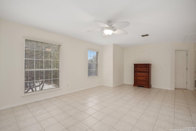 spare room featuring light tile patterned floors and ceiling fan