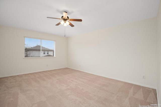 carpeted empty room featuring ceiling fan