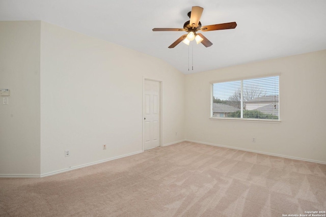 unfurnished room with ceiling fan, light colored carpet, and vaulted ceiling