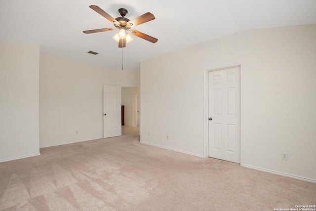 spare room featuring ceiling fan and light carpet